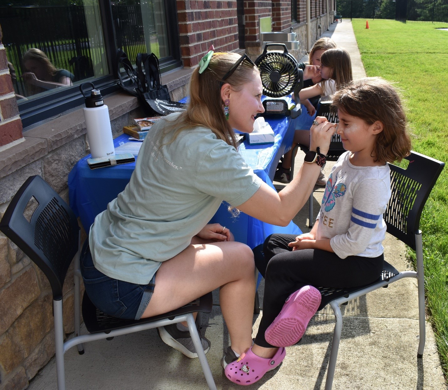 A person applying makeup to a child's faceAI-generated content may be incorrect., Picture