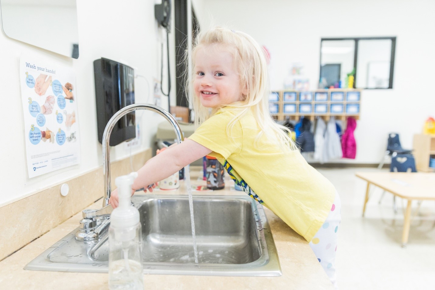 A child washing hands in a sinkAI-generated content may be incorrect., Picture