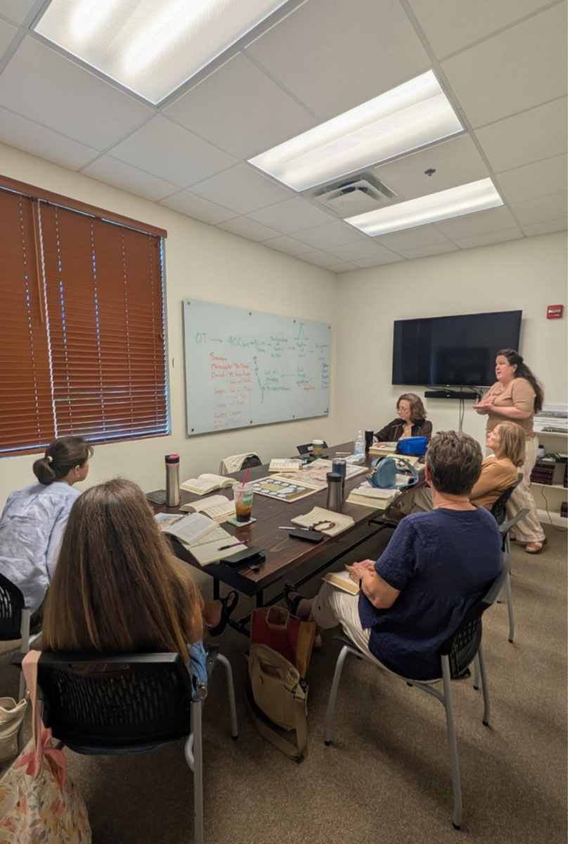 A group of people sitting at a tableAI-generated content may be incorrect.